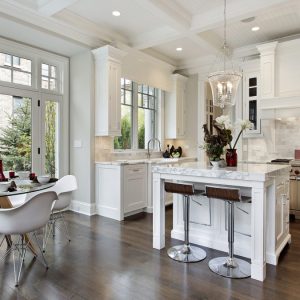 Kitchen in luxury home with white cabinetry.